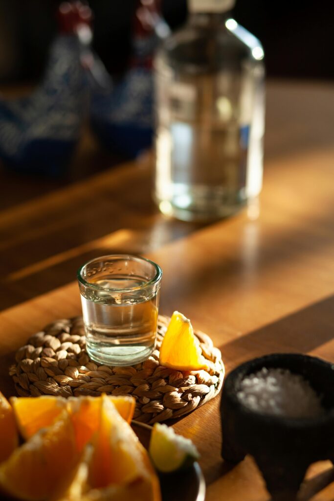 A shot of mezcal with an orange slice and sal de gusano, a classic pairing found in Mexico City’s vibrant mezcalerías.
