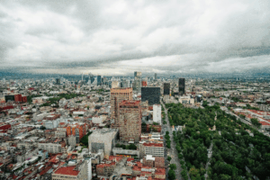 Expansive view of Mexico City’s skyline at dusk, capturing the vibrant sprawl and complexity portrayed in First Stop in the New World — a compelling nonfiction portrait featured in books and films about Mexico City.