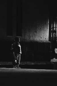 Solitary figure walking through a shadowy Mexico City street — evoking the introspective and symbolic themes of identity and ritual in Octavio Paz’s The Labyrinth of Solitude.