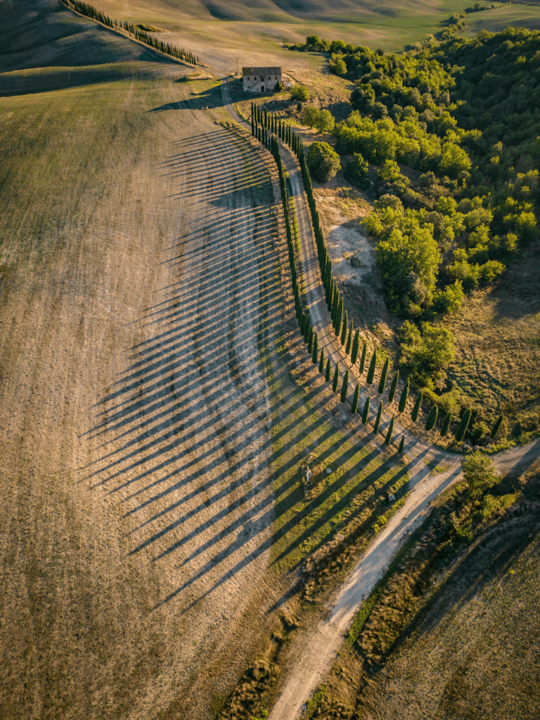 Aerial view of Tuscan villa and vineyards — evoking the bohemian summer setting of Stealing Beauty and other romantic movies set in Tuscany.