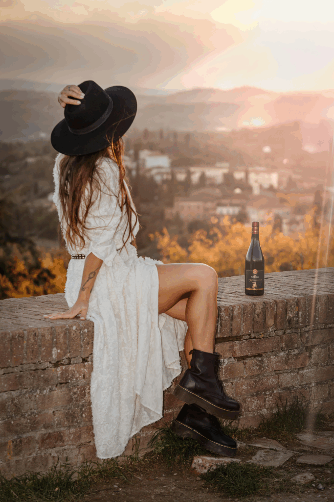 Woman looking out over the Tuscan hills who knows what to wear in Tuscany.