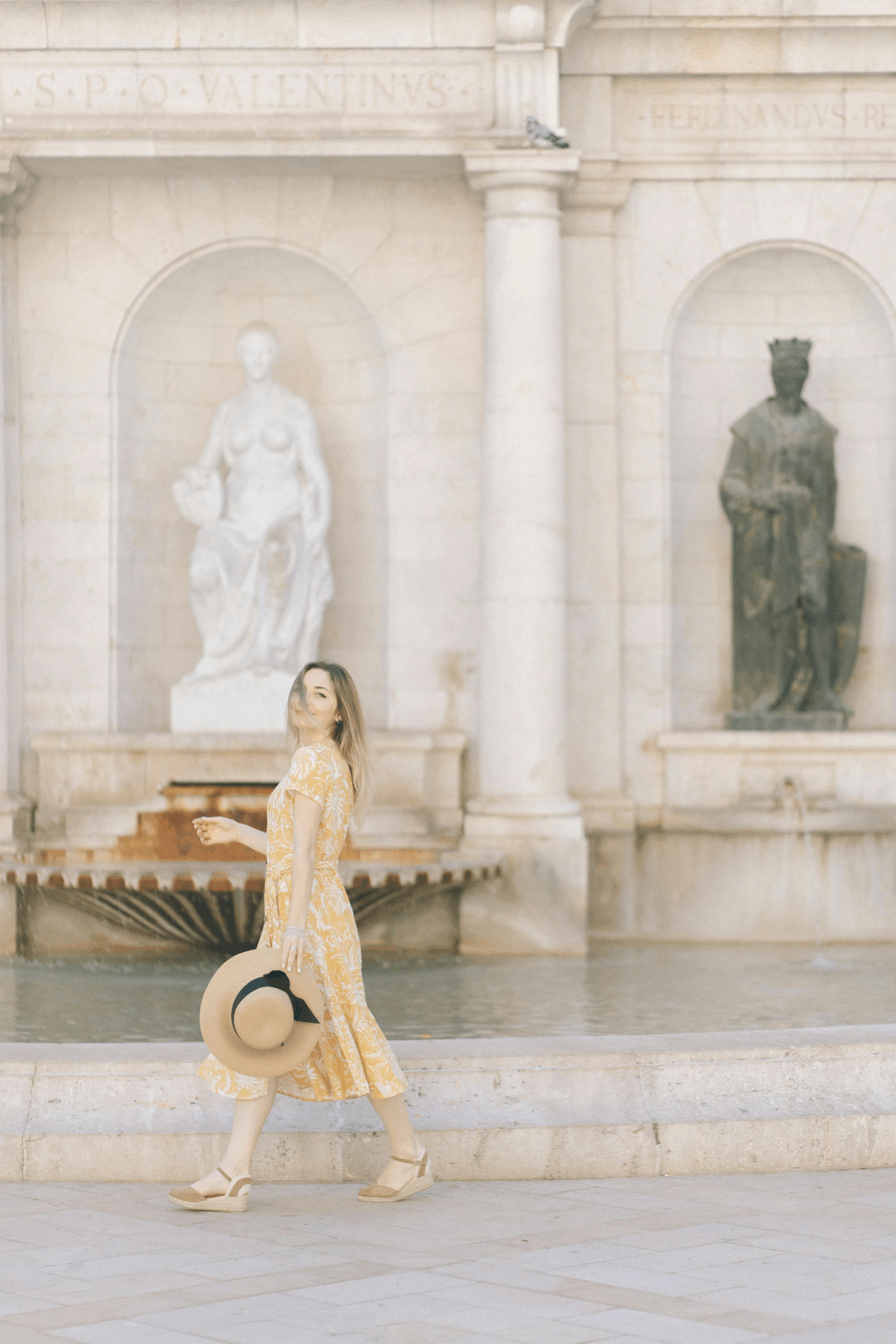 Traveler in neutral dress overlooking Tuscan hills — what to wear in Tuscany for summer evenings.