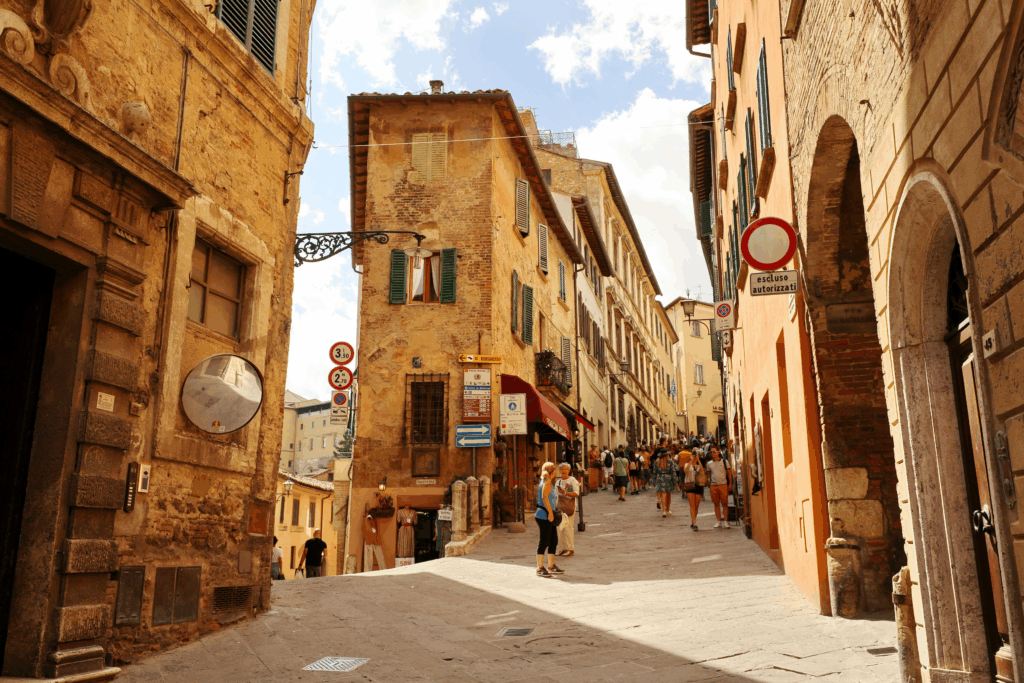 Historic cobblestone street in Montepulciano, known for Renaissance architecture and Tuscan wine culture.