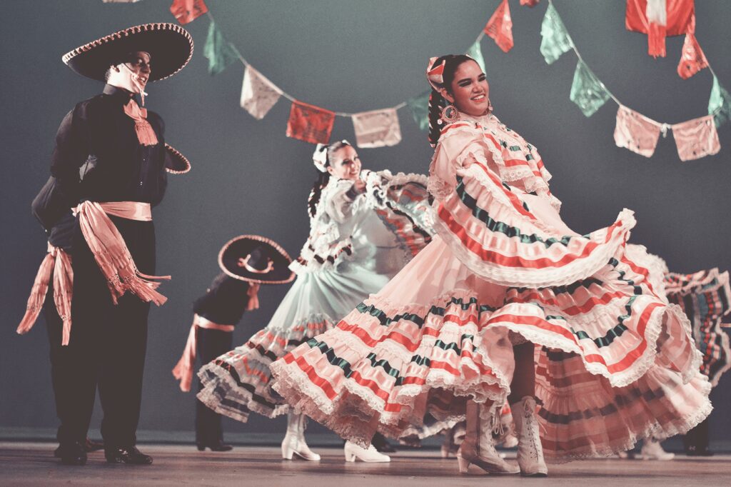 Dancers in vibrant traditional dress performing at the Ballet Folklórico de México, held at the iconic Palacio de Bellas Artes in Mexico City