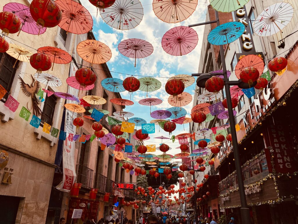 Colorful street in Mexico City decorated with umbrellas and papel picado, capturing the vibrant spirit of the city featured in this travel planning guide