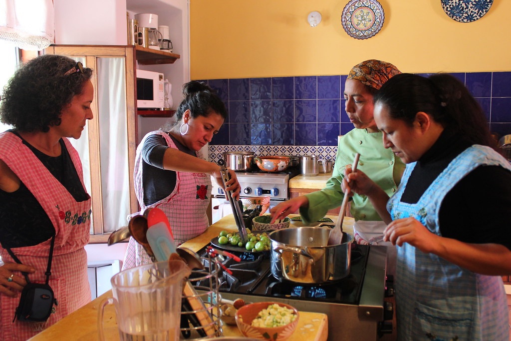 Private cooking class in a historic Coyoacán kitchen, with a local chef guiding three travelers through traditional Mexican recipes